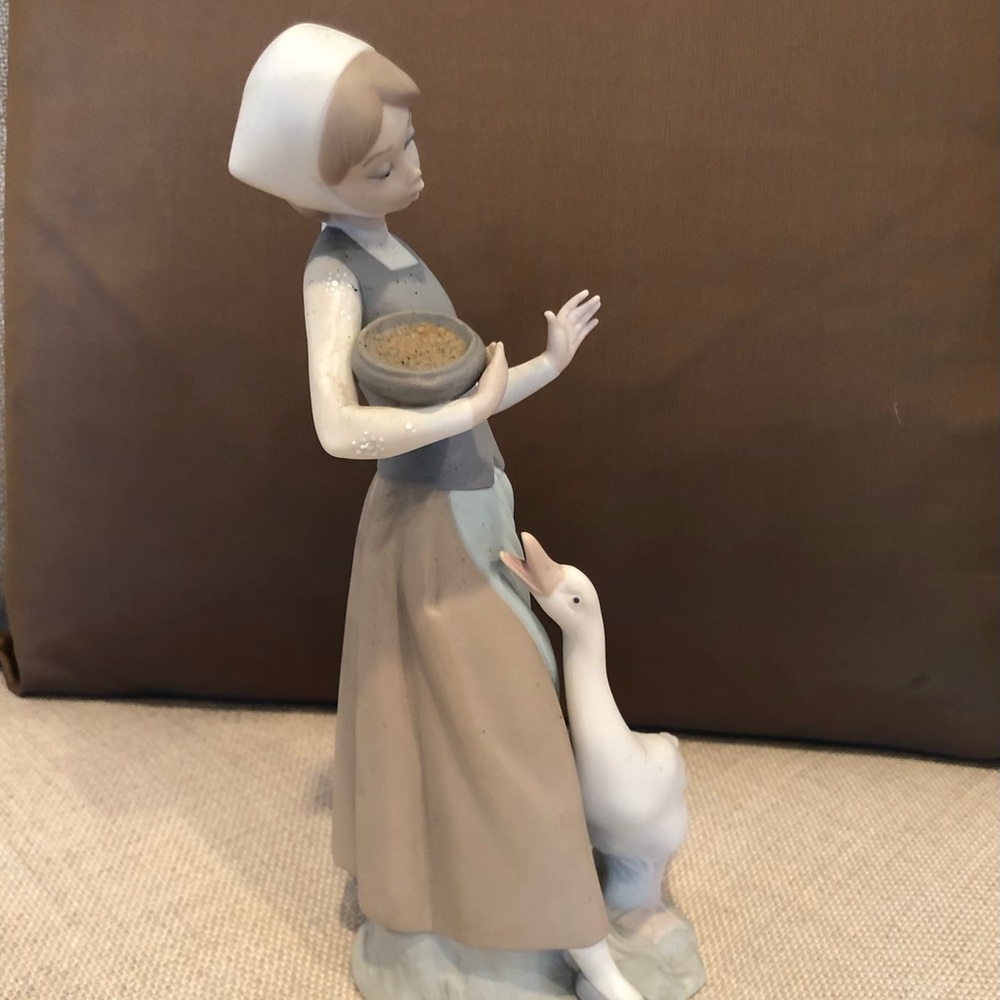 Lladro matte porcelain figurine. Girl feeding duck